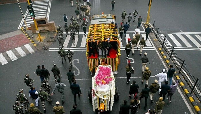 Officers lead the coffin of India’s late former prime minister Manmohan Singh, for a state funeral ceremony in New Delhi on Dec 28, 2024. — AFP