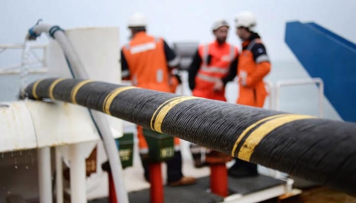 In this photo, engineers can be seen installing a submarine cable. — AFP/File