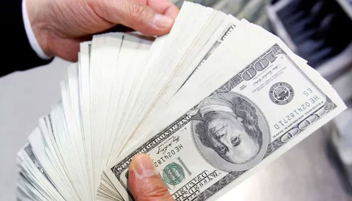 An employee of an Exchange Bank counts one hundred US dollar notes during a photo opportunity at the banks headquarters in Seoul April 28, 2010. — Reuters