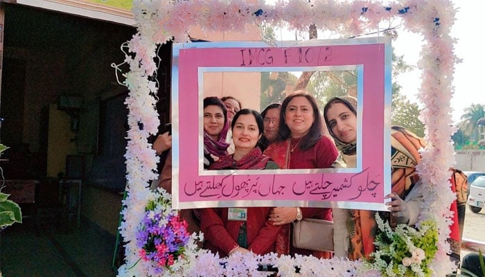 Participants seen taking a group photo at  Kashmir Jannat Nazeer festival at the Islamabad Model College for Girls, F-8/1