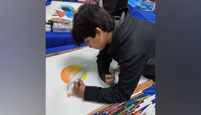 This representational image shows a school student participating in a painting competition on February 20, 2024. — Facebook@Riphah International University