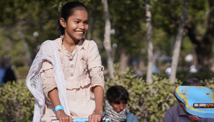 A girl seen on a seesaw in an event organised by the Green Crescent Trust.— Facebook@gct.org.pk/File