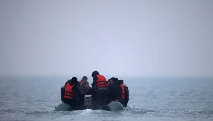 A group of people on an inflatable dinghy leave the coast of northern France to cross the English Channel, near Wimereux, France, November 24, 2021.—Reuters