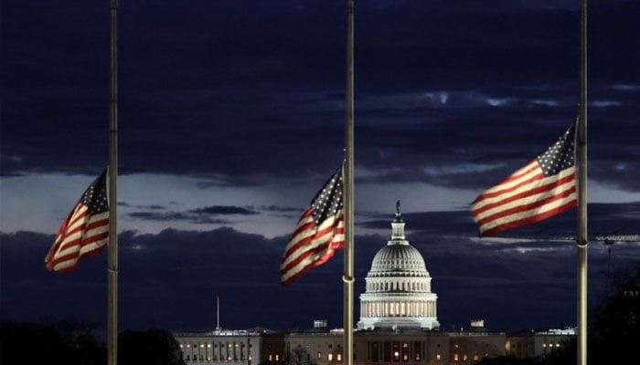 With the US Capitol in the distance, flags fly at half-staff at the Washington Monument on the National Mall following the death of former US President Jimmy Carter, in Washington, US. —Reuters/File