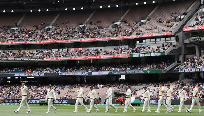 Members of the Australia team take the pitch for the start of action against England in the third Ashes test at Melbourne Cricket Ground in Melbourne, Australia, December 26, 2021. — Reuters