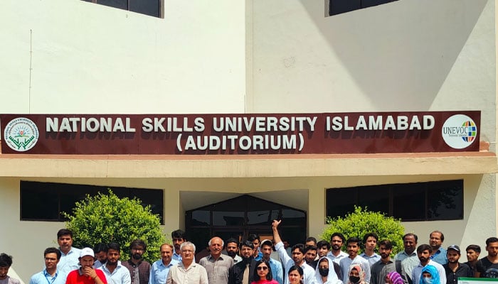 People seen taking a group photo in front of the National Skills University (NSU) Islamabad.— Facebook@NSUIslamabad/File