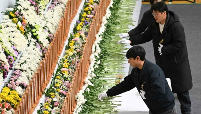 Mourners pay their respects at a memorial altar for victims of the Jeju Air plane crash, at Muan Sports Park in Muan on December 30, 2024. — AFP