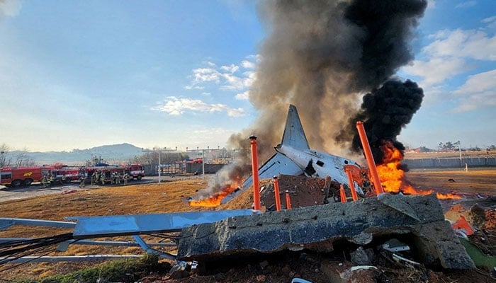 Firefighters carry out extinguishing operations on an aircraft which drove off runway at Muan International Airport in Muan, South Jeolla Province, South Korea on December 29, 2024. — Reuters