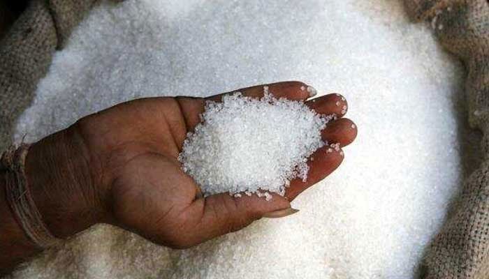 Sugar in a gunny bag scooped up by a seller for photographing up close. — AFP/File