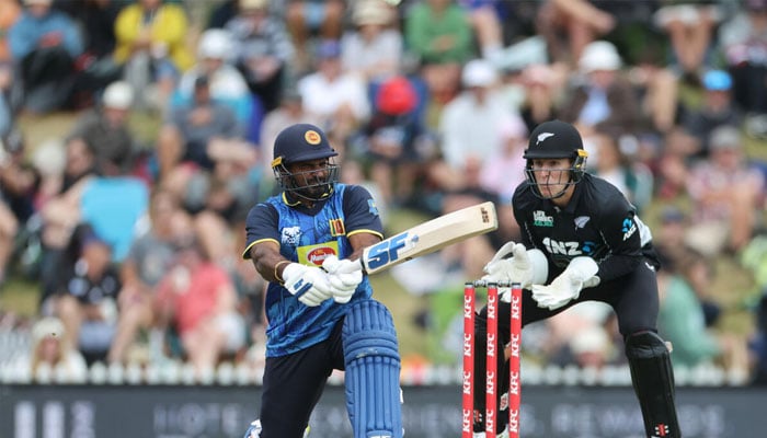 Sri Lankas Kusal Perera plays a shot as New Zealand wicketkeeper Mitch Hay looks on during the third Twenty20. — AFP/File