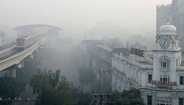 An Orange Line Metro Train is pictured on an elevated track amid smoggy conditions in Lahore on November 3, 2024. — AFP