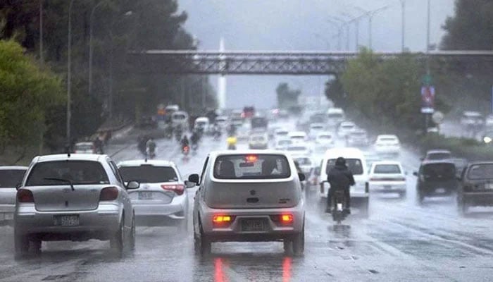 Traffic moves during heavy rain at the Islamabad Expressway in the federal capital. — APP/File