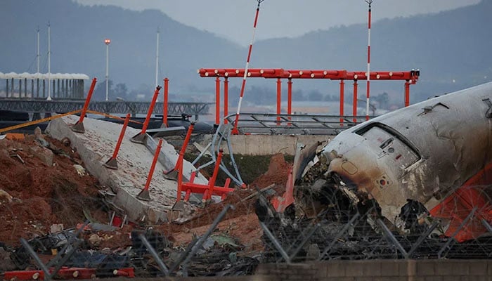 The wreckage of the Jeju Air aircraft that went off the runway and crashed at Muan International Airport lies near a concrete structure it crashed into, in Muan, South Korea, December 30, 2024. — Reuters