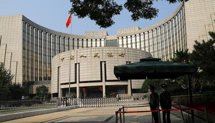 Paramilitary police officers stand guard in front of the headquarters of the Peoples Bank of China, the central bank (PBOC), in Beijing, China September 30, 2022. — Reuters