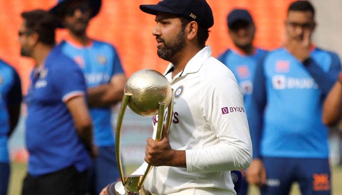 Indias Rohit Sharma receives the Border Gavaskar trophy after winning the test series on March 13, 2023. — Reuters