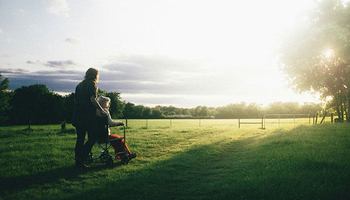 The representational image shows a person tending an elderly woman. — Unsplash/File