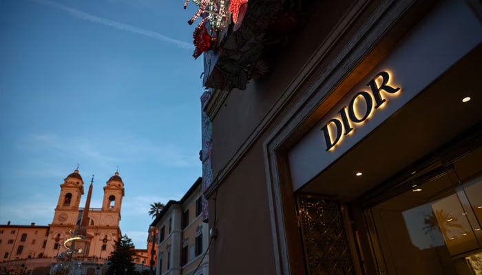 A Dior sign is seen in a shop with the Church of Santissima Trinita dei Monti and the Spanish Steps in the background, in Rome, Italy, December 18, 2024. —Reuters