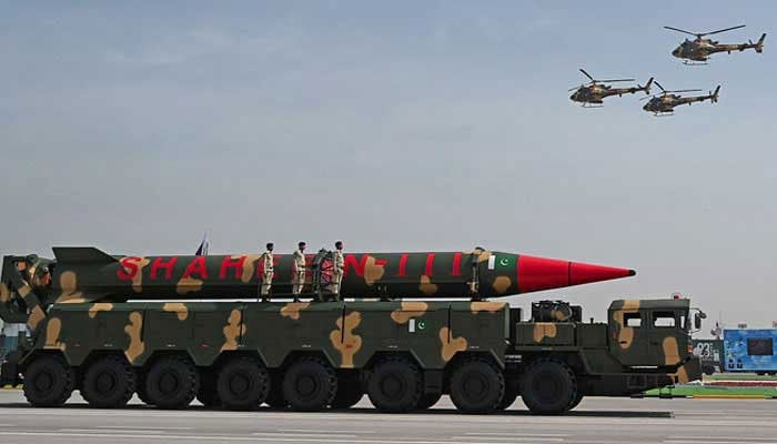 Pakistani military helicopters fly past a vehicle carrying a long-range ballistic Shaheen III missile take part in a military parade to mark Pakistans National Day in Islamabad on March 25, 2021. — AFP