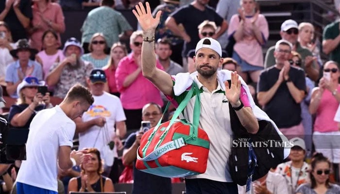 Dimitrov waves to the crowd after he retired injured in the mens singles semi-final at the Brisbane International. — AFP/File