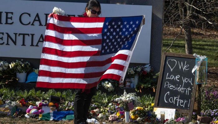 Angela Abreu from Miami, Florida visits a makeshift memorial outside of the Carter Center on January 04, 2025 in Atlanta, Georgia.— AFP/File