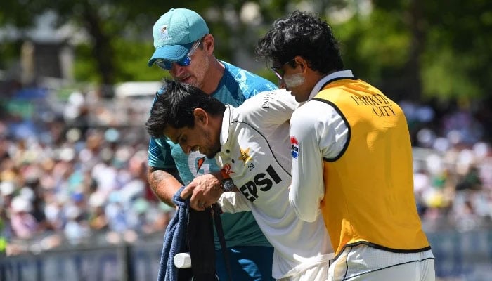 Saim Ayub is assisted off the field after being injured during the first day of the second international Test cricket match between South Africa and Pakistan at Newlands stadium in Cape Town on January 3, 2025. — AFP