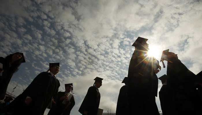 A representational image showing the silhouette of students wearing graduation caps. — Reuters/File