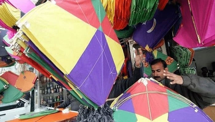 A kite-vendor awaits customers at his shop. — Reuters/File