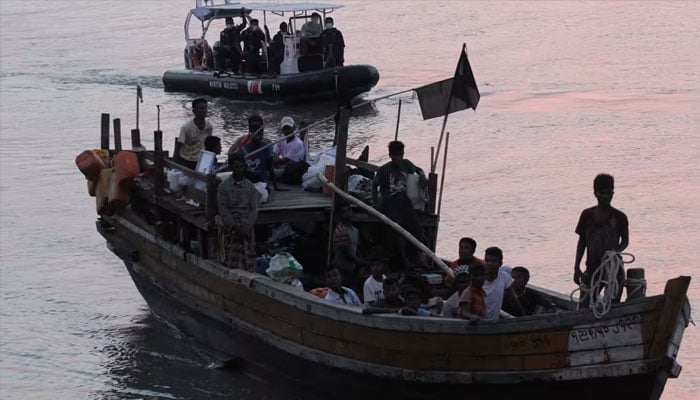 Rohingya refugees are escorted in their boat as they are handed over to immigration authorities at the Kuala Kedah ferry jetty in Malaysia on April 3, 2018. —Reuters