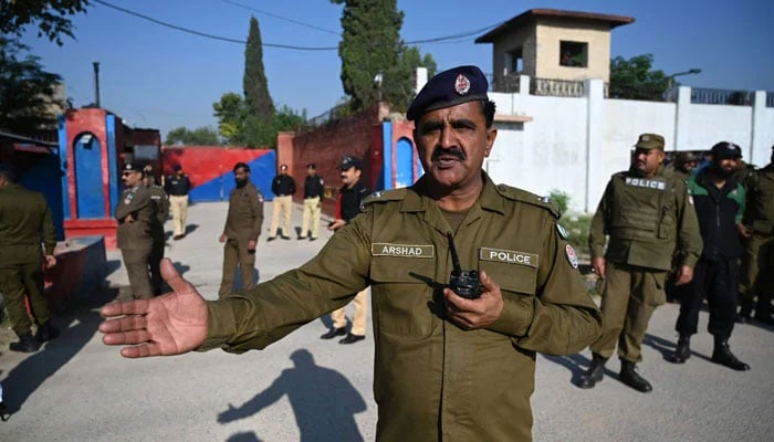 Police officials stand guard outside the Adiala Jail, in Rawalpindi on October 23, 2023. — AFP