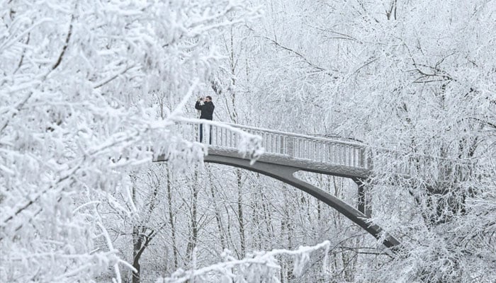 A person taking the images using his phone. — AFP/File