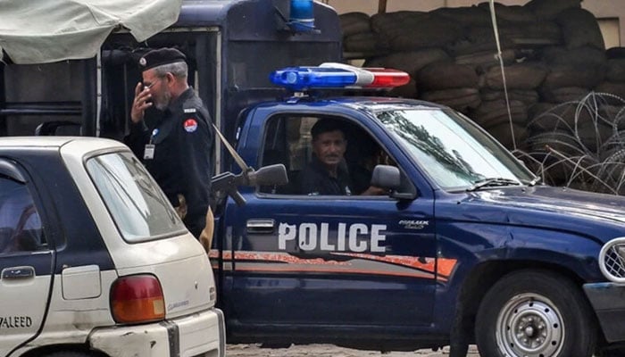 Punjab Police officials stand guard at a checkpoint. — AFP/File