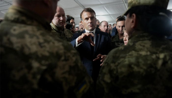 French President Emmanuel Macron speaks with Ukrainian soldiers during a visit to a military camp in eastern France in October, 2024. —AFP/File