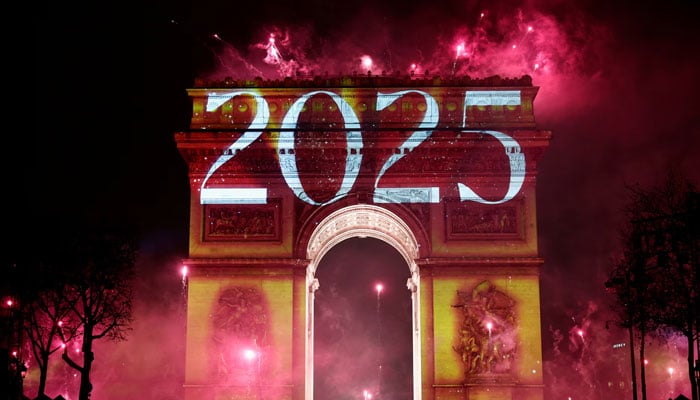 Fireworks explode as 2025 is projected onto The Arc de Triomphe during the New Years celebrations on the Champs Elysees avenue in Paris, France on January 1. — Reuters