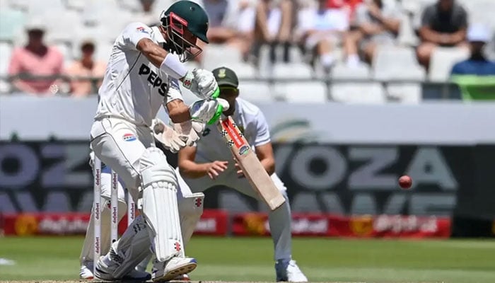 Pakistan’s Shan Masood (left) watches the ball after playing a shot during the fourth day of the second international Test cricket match between South Africa and Pakistan at Newlands stadium in Cape Town on January 6, 2025. — AFP