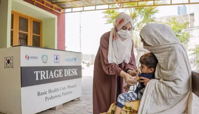 A nurse injects a child in rural Peshawar. — UNICEF Pakistan web/file