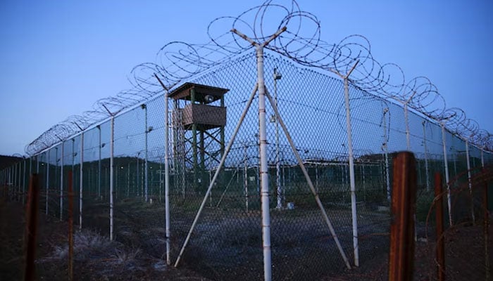 Chain link fence and concertina wire surrounds a deserted guard tower within Joint Task Force Guantanamos Camp Delta at the US Naval Base in Guantanamo Bay, Cuba, March 21, 2016. — Reuters