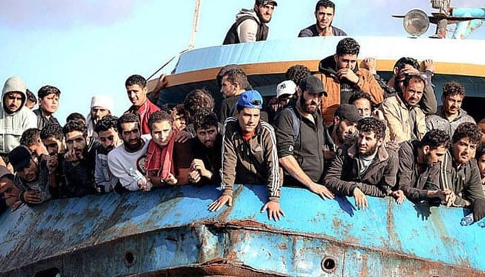 This representational image shows people on a boat travelling by sea from their respective countries. — AFP/File