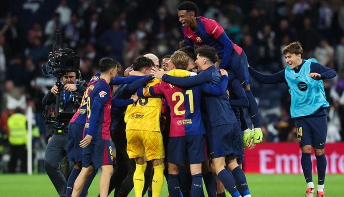 FC Barcelona players celebrate at the end of their Spanish league football match between Real Madrid CF and FC Barcelona at the Santiago Bernabeu stadium in Madrid on October 26, 2024. —AFP/File