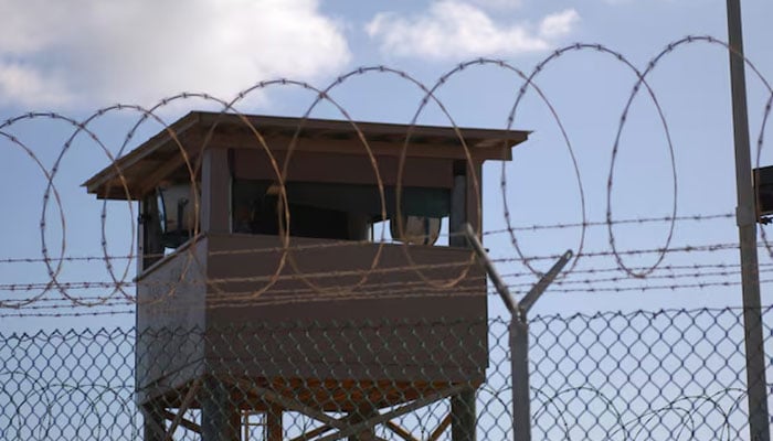 A soldier stands guard in a tower at Guantanamo Bay naval base on December 31, 2009.  — Reuters