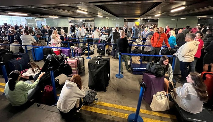 Visitors to the UK from dozens of countries waiting at an airport. — Reuters/File