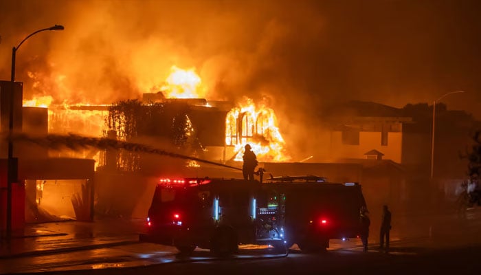 Firefighters battle the Palisades Fire while it burns homes on the Pacific Coast Highway amid a powerful windstorm on 8 January 2025 in Los Angeles, California. . —AFP