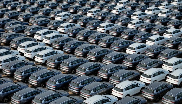 Newly manufactured cars parked near a port in China. — AFP/File