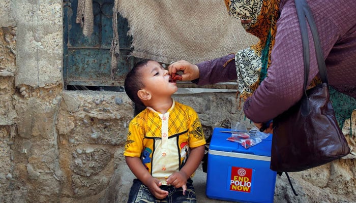 A boy receives polio vaccine drops, during an anti-polio campaign, in a low-income neighborhood in Karachi. — Reuters/File