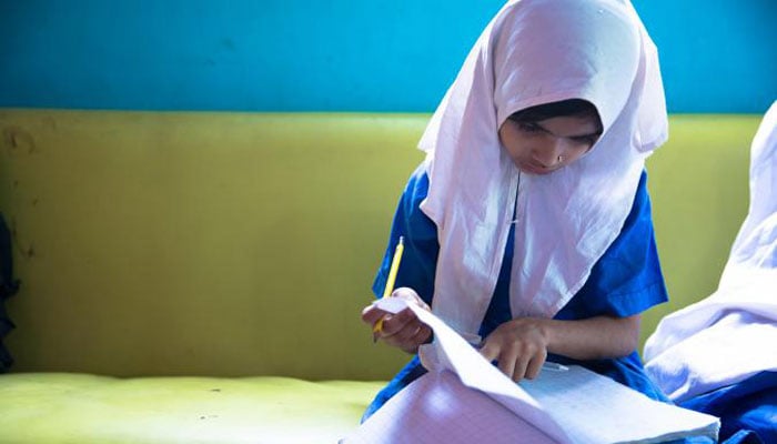 The representational image shows a little girl in school uniform.  — Screengrab via HRW website