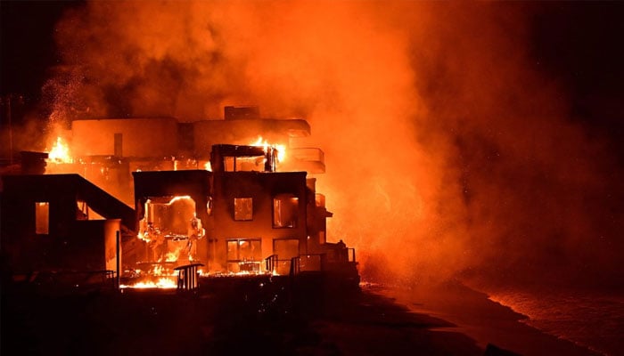 A beach house is engulfed in flames as the Palisades Fire burns along Pacific Coast Highway in Malibu, California, US, January 8, 2025. —AFP