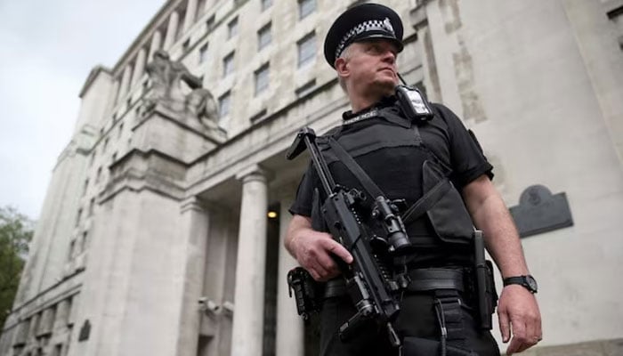 An armed police officer patrols near the Ministry of Defence in London, Britain May 11, 2016.— Reuters