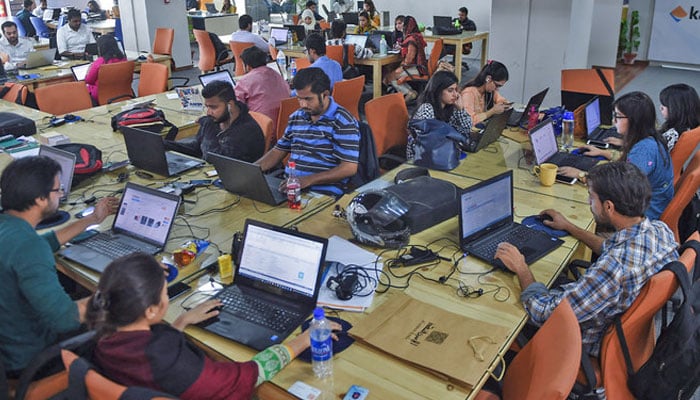 This photograph taken on November 19, 2015 shows employees of online marketplace company in Karachi, Pakistan. — AFP