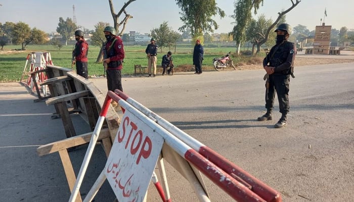 Pakistani soldiers stand guard on a road leading to the cantonment area in Bannu, Pakistan December 20, 2022. — Reuters