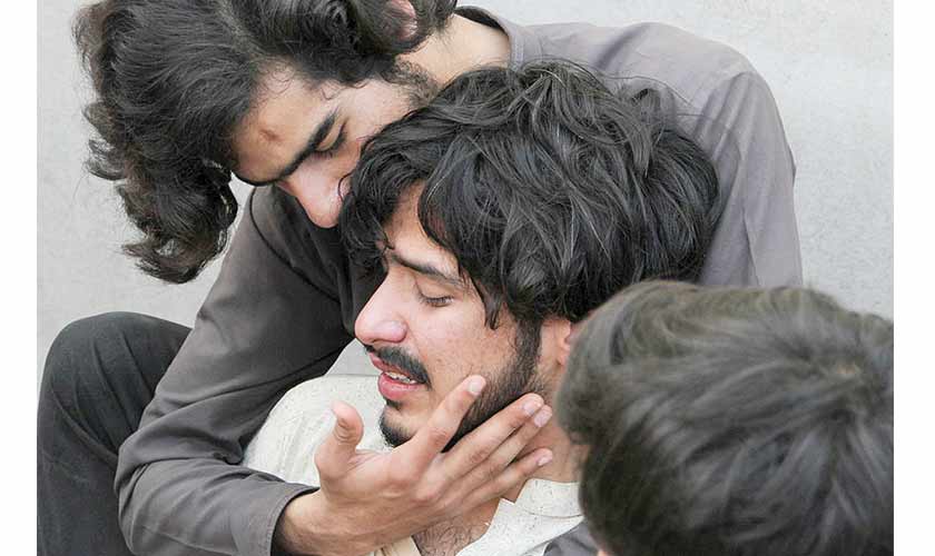 Relatives of the victims comfort each other, after a bomb blast in a mosque during Friday prayers in Peshawar. Image courtesy: Reuters