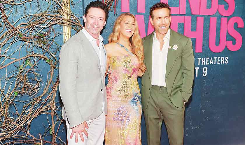 Blake Lively at the premiere of It Ends With Us with her husband Ryan Reynolds and Hugh Jackman (Reynold’ co-star in Deadpool and Wolverine.) Lively made a statement in a vintage Versace dress, previously worn by Britney Spears at a 2002 Versace fashion show. The sheer, sequined gown featured a colorful, butterfly-inspired design that captured the attention of everyone on the red carpet.